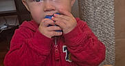 Owen Swartz is registered to the contest to win money with this photo: toddler, child, indoor, red_jacket, blonde_hair, blue_eyes, holding_object, curious, person, furniture, pillar, legs, cozy_clothing, portrait, young_child, looking_up, home, cute, casual, baby