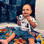 Isaiah joined the competition — help win amazing prizes! toddler, child, toy_car, american_flag, quilt, teddy_bear_pattern, shirt, shorts, indoor, happy, smiling, sitting, fabric, patchwork, play, person, wall, foot, hand, face