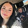 Isaiah is registered to the contest to win money with this photo: woman, child, car, car_seat, seatbelt, smile, baby, hair, face, window, sunlight, clothing, interior, seat, person, happy, portrait, baby_bottle, road_trip, family