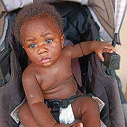Davell joined the competition — help win amazing prizes! baby, child, stroller, blue_eyes, curious, infant, seat_belt, diaper, hand, portrait, skin, hair, expression, indoor, comfortable, young_child, person, baby_boy, sitting, closeup