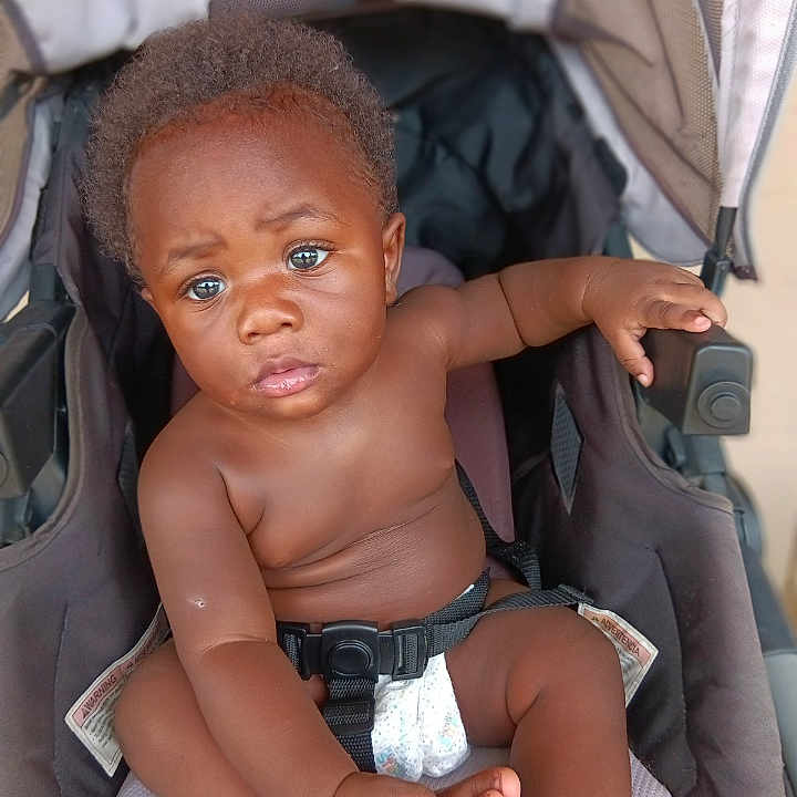 Davell joined the competition — help win amazing prizes! baby, child, stroller, blue_eyes, curious, infant, seat_belt, diaper, hand, portrait, skin, hair, expression, indoor, comfortable, young_child, person, baby_boy, sitting, closeup