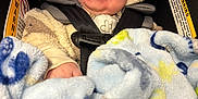 Levi is registered to the contest to win money with this photo: baby, infant, smiling, smile, hood, hooded_jacket, fuzzy_blanket, car_seat, seat_belt, blue_blanket, plush, cute, happy, chubby_cheeks, portrait, closeup, bright_eyes, hand, winter_clothing, warning_label