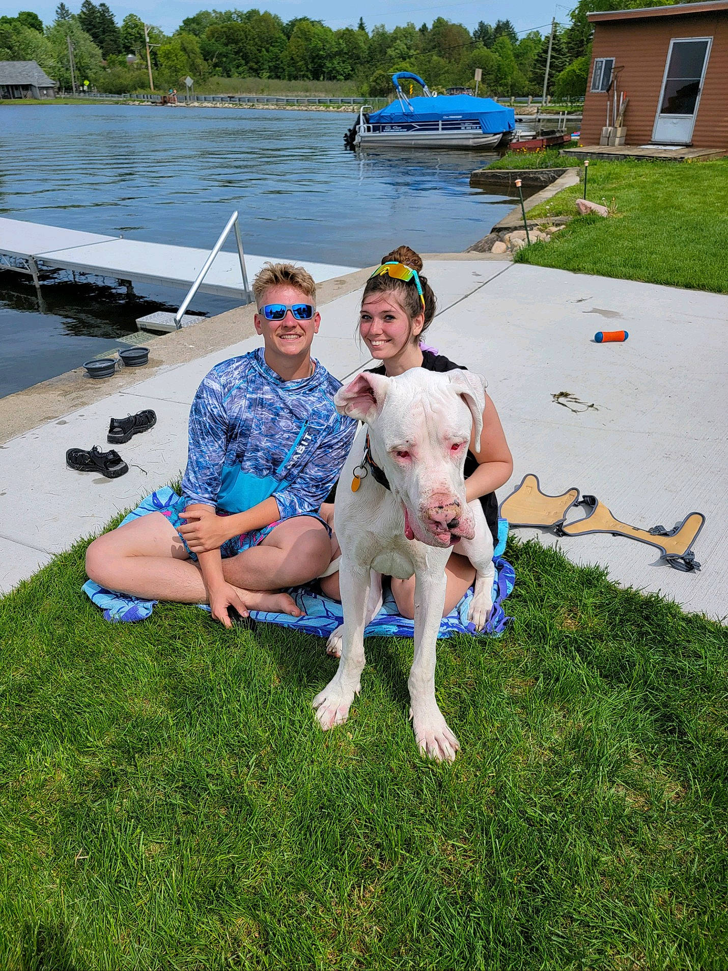 Hoss Boss joined the competition — help win amazing prizes! boats_and_boating_equipment_and_supplies, carnivore, companion_dog, dog, dog_breed, grass, lake, lawn, leisure, recreation, shorts, sky, smile, summer, sunglasses, t_shirt, tree, water, watercraft, window