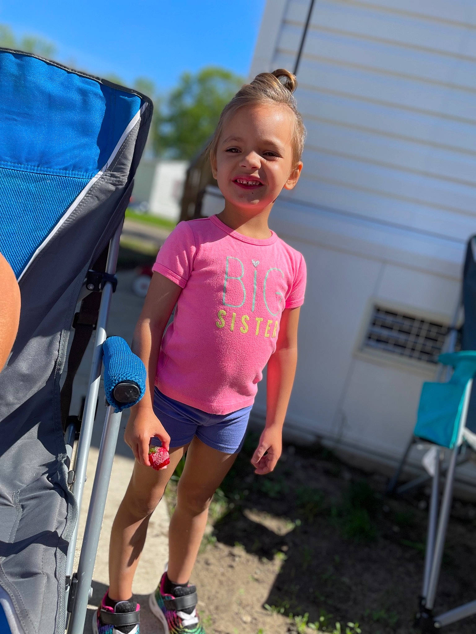 Avah is registered to the contest to win money with this photo: blue, chair, child, electric_blue, fun, grass, happy, joy, leisure, magenta, person, play, recreation, sandal, shorts, sky, smile, t_shirt, toddler, travel