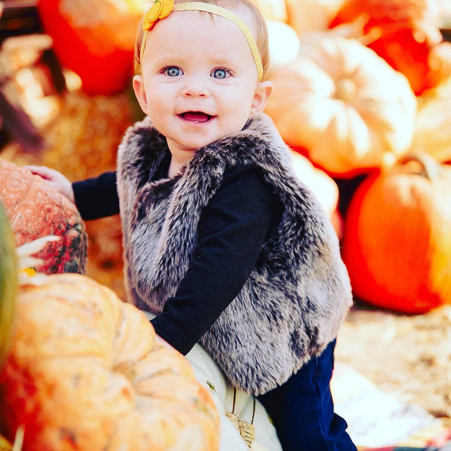Kinlee is registered to the contest to win money with this photo: baby_toddler_clothing, calabaza, child, cucurbita, eye, facial_expression, gourd, happy, natural_foods, orange, organ, people, people_in_nature, person, photograph, plant, pumpkin, smile, squash, toddler