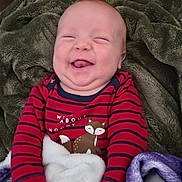Milo is registered to the contest to win money with this photo: baby, blanket, child, comfortable, cozy, cute, expression, face, fleece_blanket, fox_print, hands, happy, indoors, infant, portrait, red_striped_clothing, sitting, smiling, soft_texture, warm