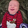 baby, blanket, child, comfortable, cozy, cute, expression, face, fleece_blanket, fox_print, hands, happy, indoors, infant, portrait, red_striped_clothing, sitting, smiling, soft_texture, warm