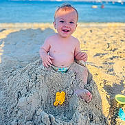 Ryan joined the competition — help win amazing prizes! baby, beach, sand, ocean, toy, smiling, child, sunlight, sand_toy, barefoot, summer, vacation, outdoor, play, happy, water, sandcastle, nature, fun, toddler
