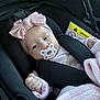 baby, infant, baby_girl, pacifier, headband, bow, car_seat, blanket, safety_harness, strap, pink, onesie, hand, portrait, close_up, seat, fabric, car_interior, sleepy, cute
