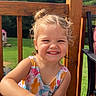 child, girl, toddler, smiling, happy, portrait, outdoor, sunny, deck, wooden_railing, backyard, trees, playhouse, summer, colorful_clothing, swimsuit, speaker, portable_speaker, hands, family_photo