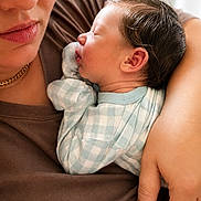 Adrian is registered to the contest to win money with this photo: arm, baby, checkered_clothing, closeup, cozy, face, family, holding, human, indoor, infant, love, mother, newborn, parent, person, skin, sleeping, soft_light, tenderness
