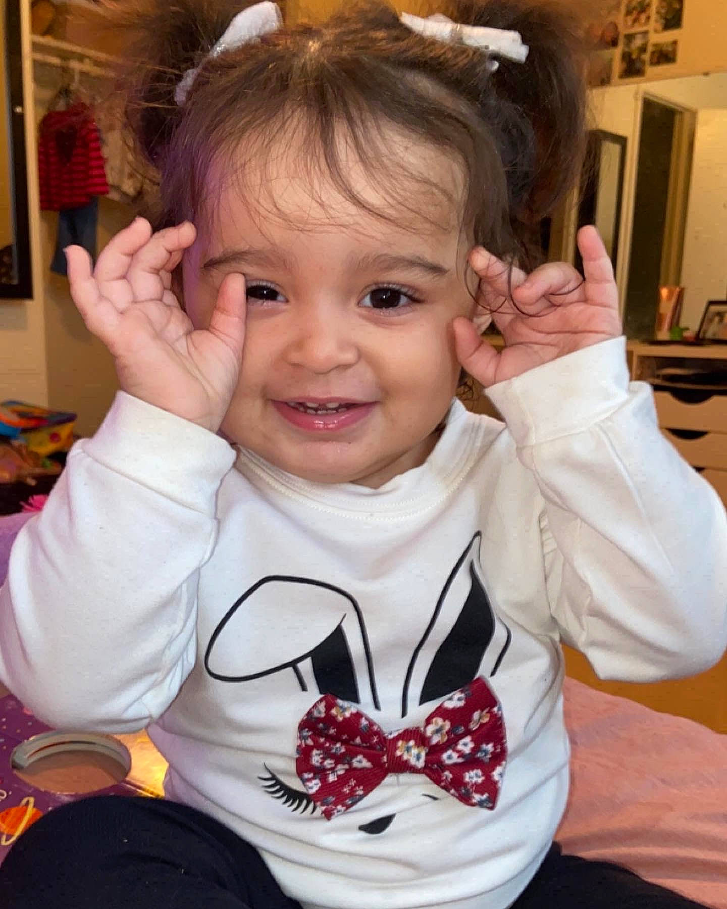 Elianna joined the competition — help win amazing prizes! baby_toddler_clothing, cheek, ear, eyelash, finger, gesture, hair, hairstyle, hand, happy, mammal, mouth, nose, organ, person, pink, skin, sleeve, smile, thumb