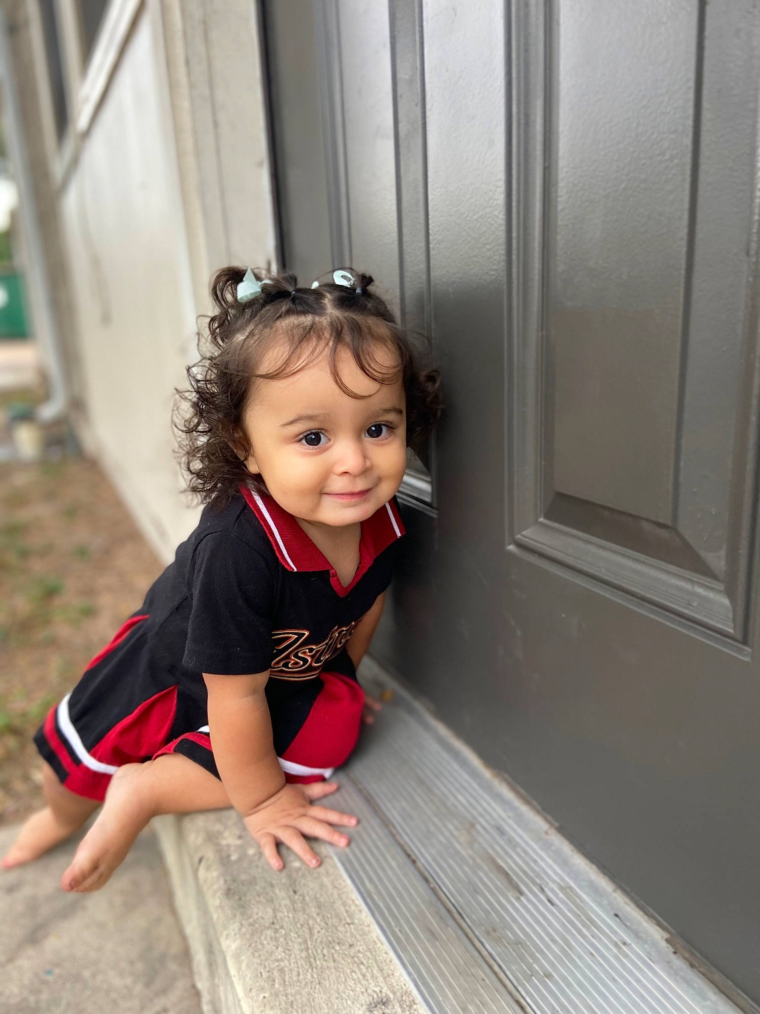 Elianna is registered to the contest to win money with this photo: baby, baby_toddler_clothing, child, dress, flash_photography, floor, flooring, fun, happy, hardwood, human_leg, leisure, person, sitting, smile, standing, t_shirt, toddler, waist, wood