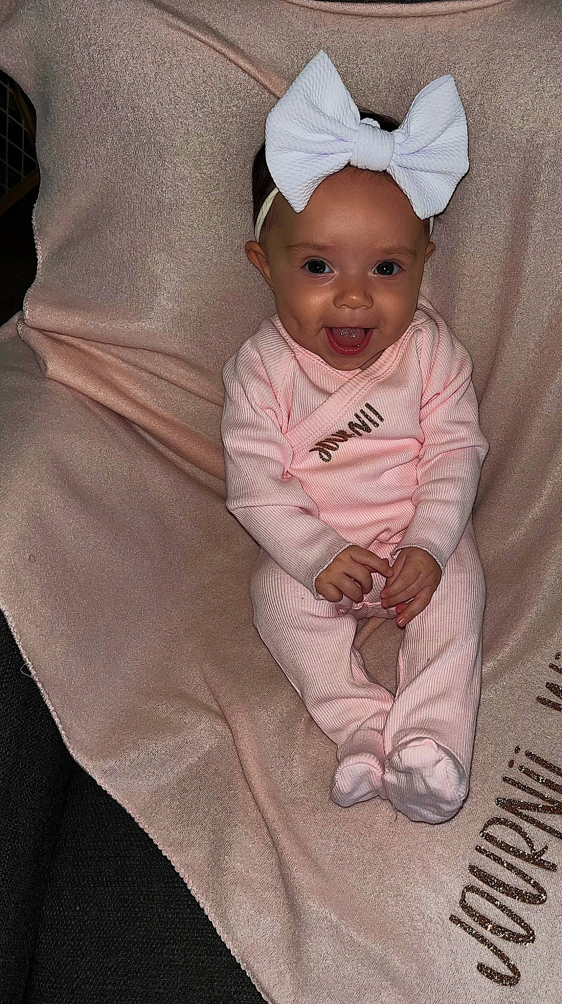 Journii is registered to the contest to win money with this photo: baby, baby_products, baby_toddler_clothing, cap, child, comfort, costume_hat, eye, face, fashion_accessory, happy, linens, magenta, pattern, person, pink, sitting, sleeve, smile, textile