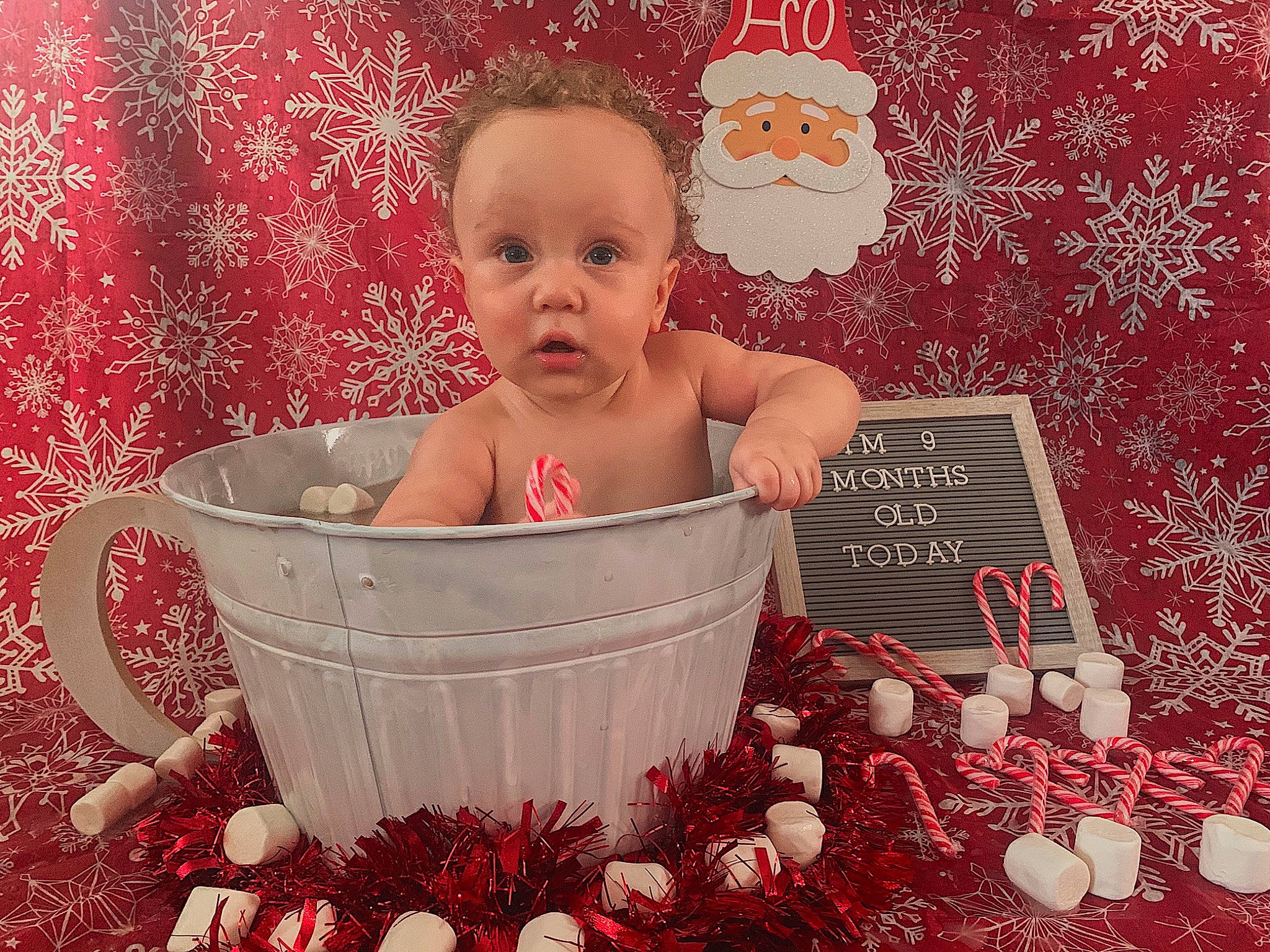Carmelo is registered to the contest to win money with this photo: baby, cheek, child, christmas, christmas_eve, cup, fictional_character, holiday, nose, person, serveware, surprise, sweetness