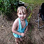child, girl, swimsuit, barefoot, outdoor, garden, plants, dirt, greenery, summer, young, cute, standing, looking_up, nature, casual, playful, blue, hair_ties, chair