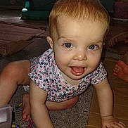 Lilliana is registered to the contest to win money with this photo: baby, child, crawling, carpet, crayons, cardboard, indoor, play, smiling, happy, person, toddler, hand, face, clothing, floor, toy, expression, curious, closeup
