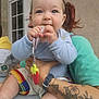 Barbara a rejoint le concours — aidez-le/la à gagner de superbes lots ! baby, child, infant, pacifier, tattoo, arm, person, clothing, shorts, window, hand, face, blue_sweater, colorful, holding, sitting, indoor, skin, cute, young