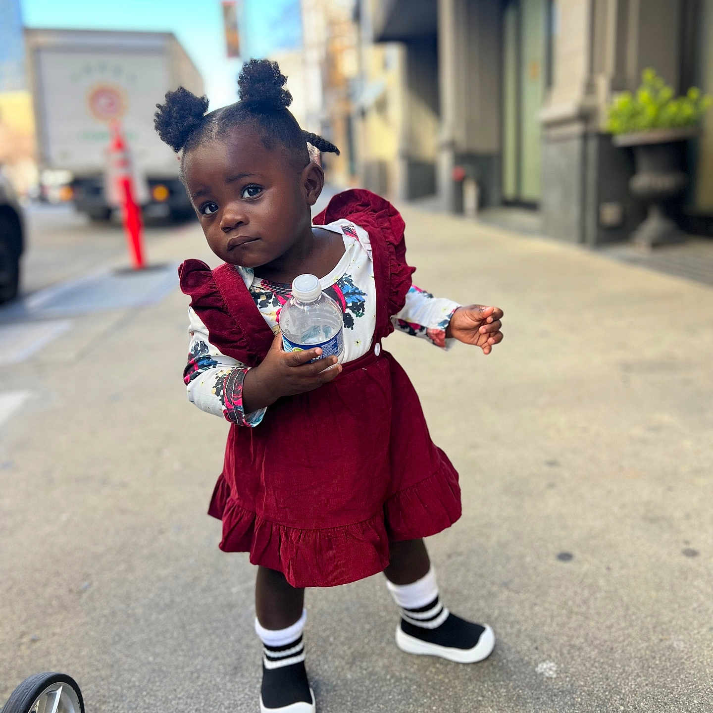 Faith is registered to the contest to win money with this photo: child, city, clothing, coat, face, female, footwear, girl, head, jacket, pants, person, photography, portrait, road, shoe, sitting, street, urban, walking