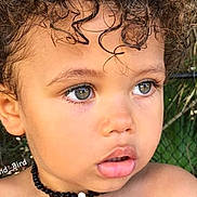 Lorenzo a rejoint le concours — aidez-le/la à gagner de superbes lots ! child, toddler, curly_hair, face, necklace, beads, skin, outdoor, portrait, expression, eyes, mouth, shoulders, young, cute, person, natural_light, closeup, head, curly