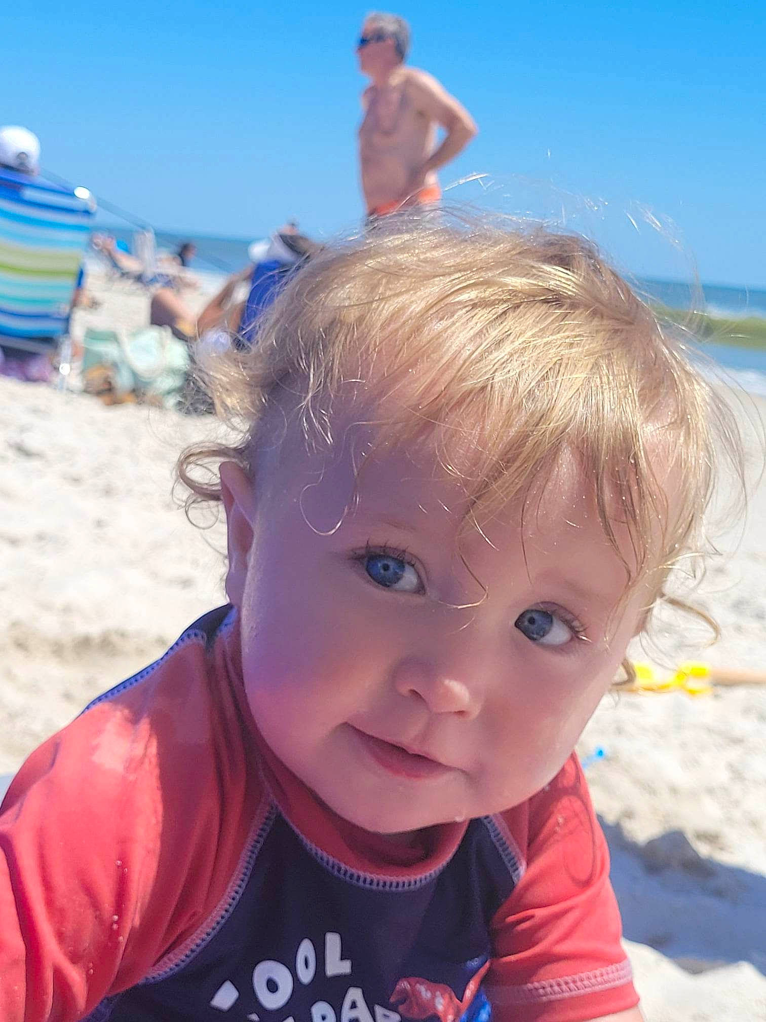 Lucas is registered to the contest to win money with this photo: azure, baby_toddler_clothing, beach, blue, body_of_water, child, electric_blue, fun, happy, holiday, leisure, ocean, people_on_beach, person, photograph, sand, sky, summer, toddler, tourism