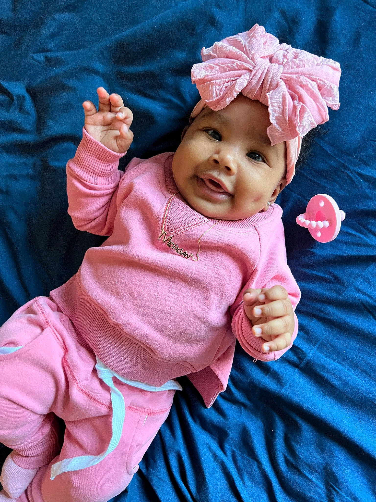 Morgan is registered to the contest to win money with this photo: baby, baby_products, baby_toddler_clothing, cheek, child, fashion_accessory, finger, fun, gesture, hand, happy, headwear, magenta, peach, person, pink, product, skin, sleeve, smile