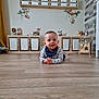 Gabriel a rejoint le concours — aidez-le/la à gagner de superbes lots ! animal_decals, baby, bib, child, cozy, curious, decor, floor, furniture, indoor, organized, person, playroom, smile, storage_bins, striped_clothing, toy, wall_decals, wooden_floor, wooden_toy