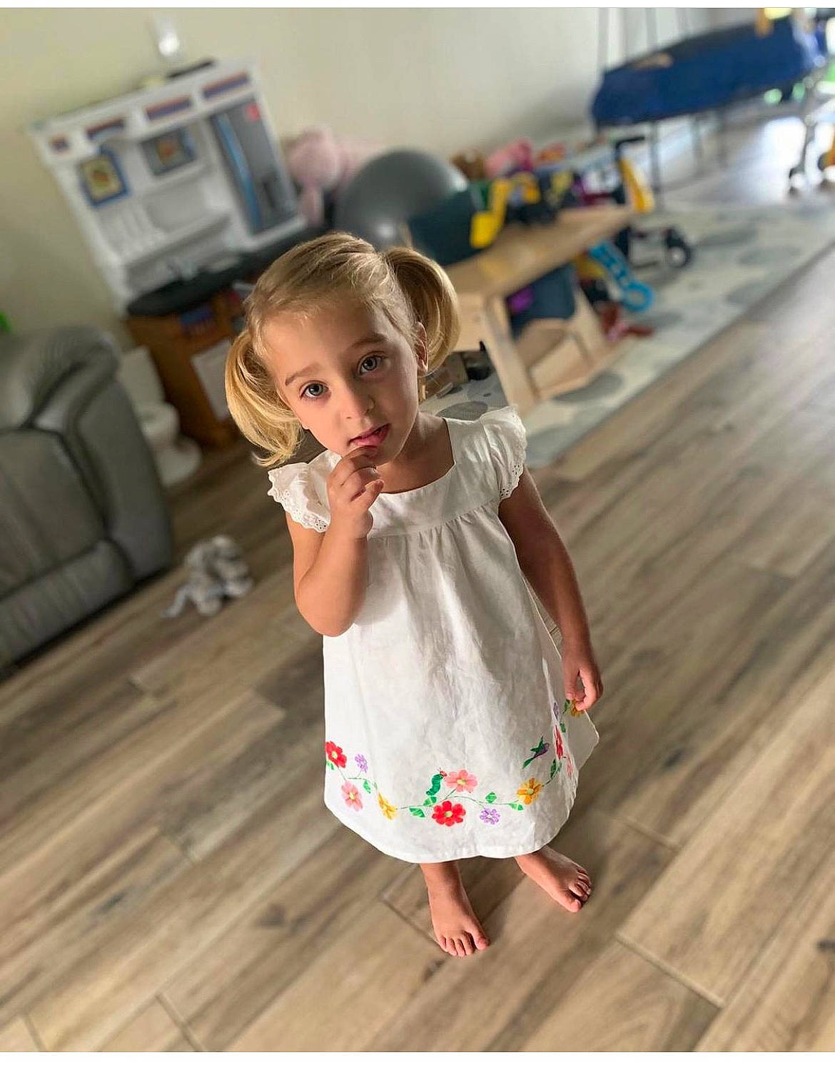 Nadia is registered to the contest to win money with this photo: baby_toddler_clothing, child, day_dress, dress, floor, flooring, fun, happy, hardwood, human_leg, jeans, laminate_flooring, long_hair, one_piece_garment, person, skin, sleeve, t_shirt, toddler, waist