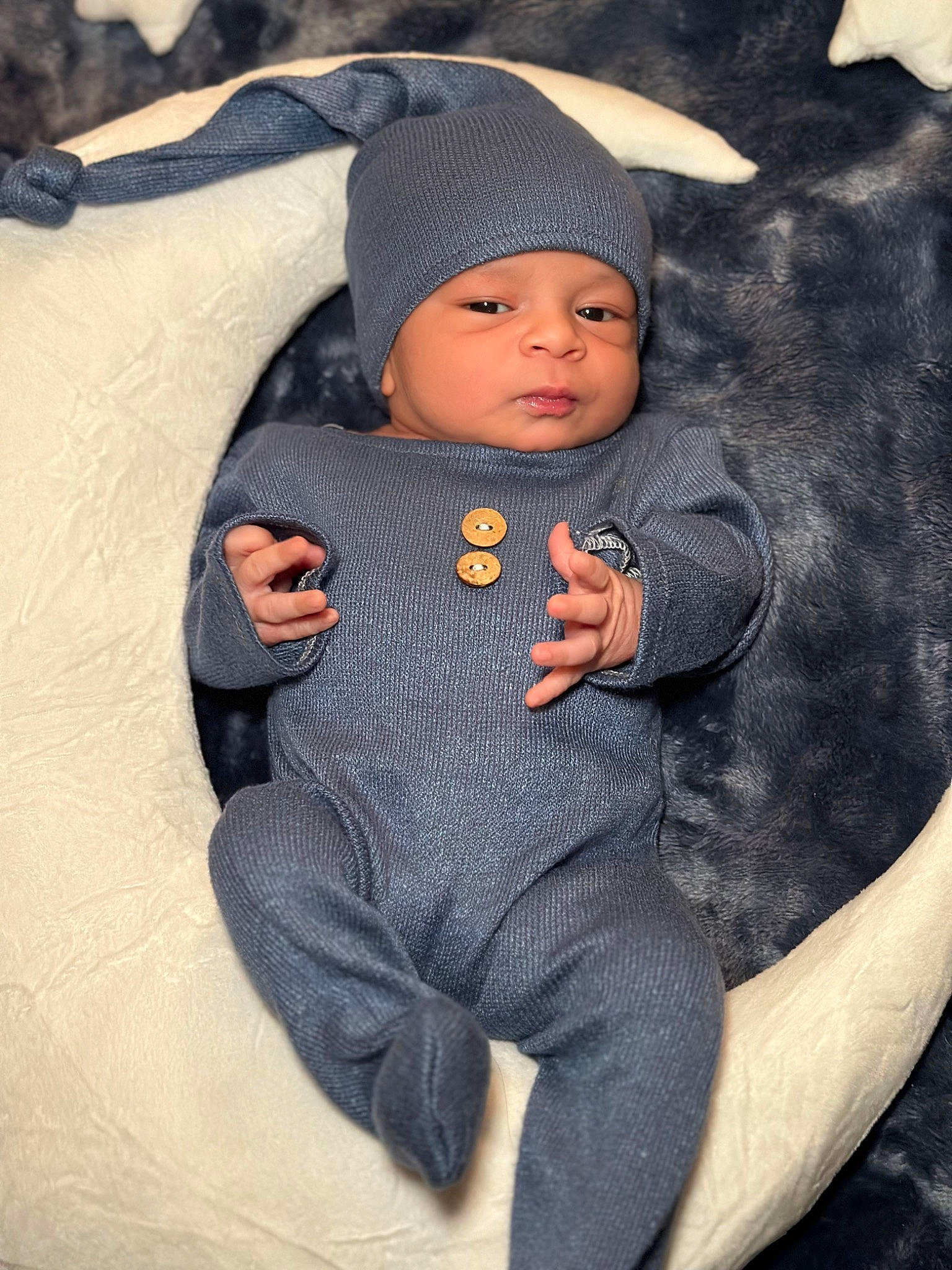 Karter is registered to the contest to win money with this photo: baby, baby_carriage, baby_products, baby_toddler_clothing, beanie, cap, cheek, child, comfort, eye, headgear, headwear, hoodie, knit_cap, linens, person, personal_protective_equipment, sitting, sleeve, textile