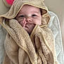 baby, towel, hood, mouse_ears, hand, face, blue_eyes, blanket, cute, infant, soft_texture, wrapped, smiling, child, portrait, indoors, cozy, warm, sleepy, adorable