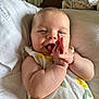 Reya joined the competition — help win amazing prizes! baby, infant, clapping, smiling, cute, cheeks, skin, arms, blanket, bed, pillow, clothing, pattern, lemon, yellow, green, happy, lying_down, face, portrait
