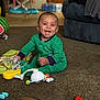 Zahkai joined the competition — help win amazing prizes! baby, child, smiling, green_onesie, carpet, toy, indoor, happy, sitting, face, person, living_room, floor, playtime, cute, infant, home, fun, joy, portrait
