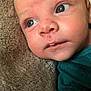 baby, infant, face, blue_eyes, skin, blanket, clothing, teal_shirt, closeup, portrait, young_child, resting, soft_texture, curious, expression, head, cheeks, nose, mouth, eyelashes
