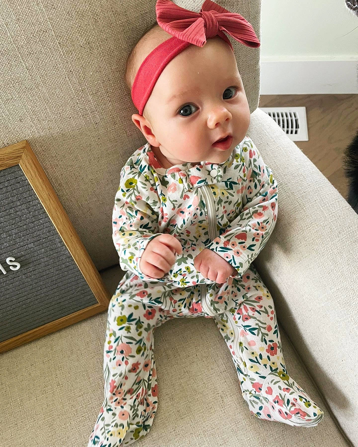 Alison joined the competition — help win amazing prizes! baby, baby_toddler_clothing, baby_toys, beanie, cap, carmine, child, costume_hat, doll, fashion_accessory, fur, headgear, military_camouflage, nightwear, outerwear, pattern, person, sitting, sleeve, toddler