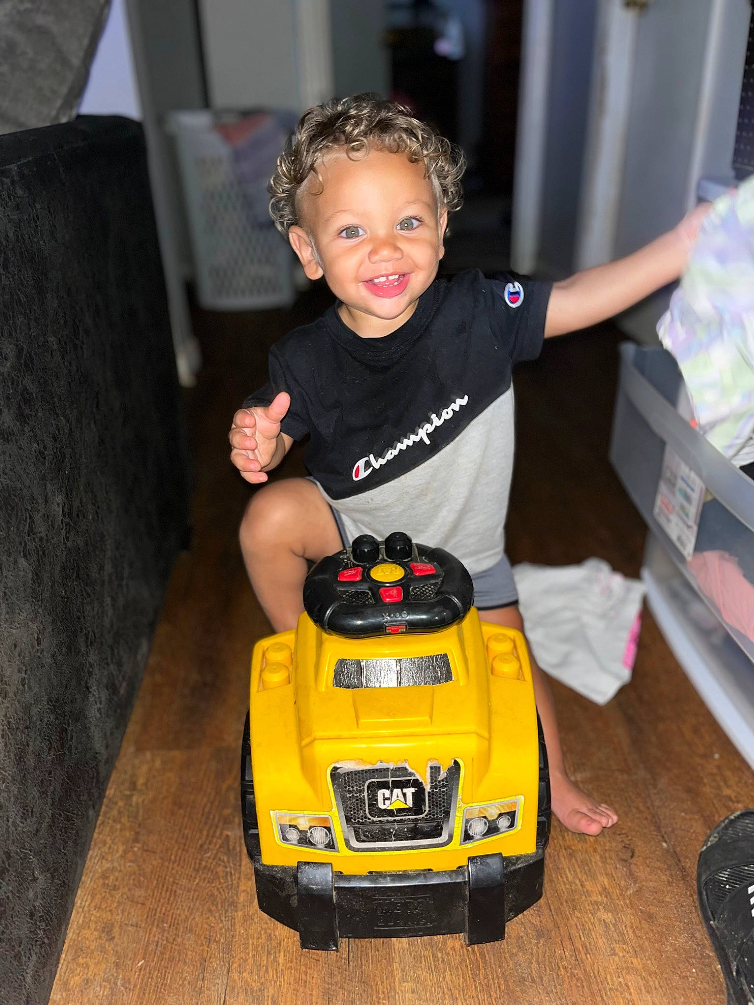 David is registered to the contest to win money with this photo: automotive_design, automotive_exterior, automotive_lighting, automotive_tire, automotive_wheel_system, baby, bumper, flooring, fun, happy, headlamp, joy, motor_vehicle, person, riding_toy, smile, tire, toddler, toy, toy_vehicle