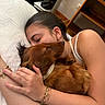 Gus participe au concours pour gagner de l'argent avec cette photo : affection, bed, bracelet, brown_dog, close_up, cute, dachshund, dog, earring, hug, human_hand, indoor, person, pet, relaxation, rest, sleep, sleeping, white_bed_sheet, wooden_furniture