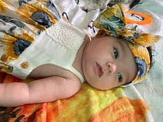 Charleigh is registered to the contest to win money with this photo: baby, baby_products, bedding, bedtime, blanket, cheek, child, comfort, eyelash, fashion_accessory, fur, happy, headwear, iris, linens, pattern, person, room, textile, toddler