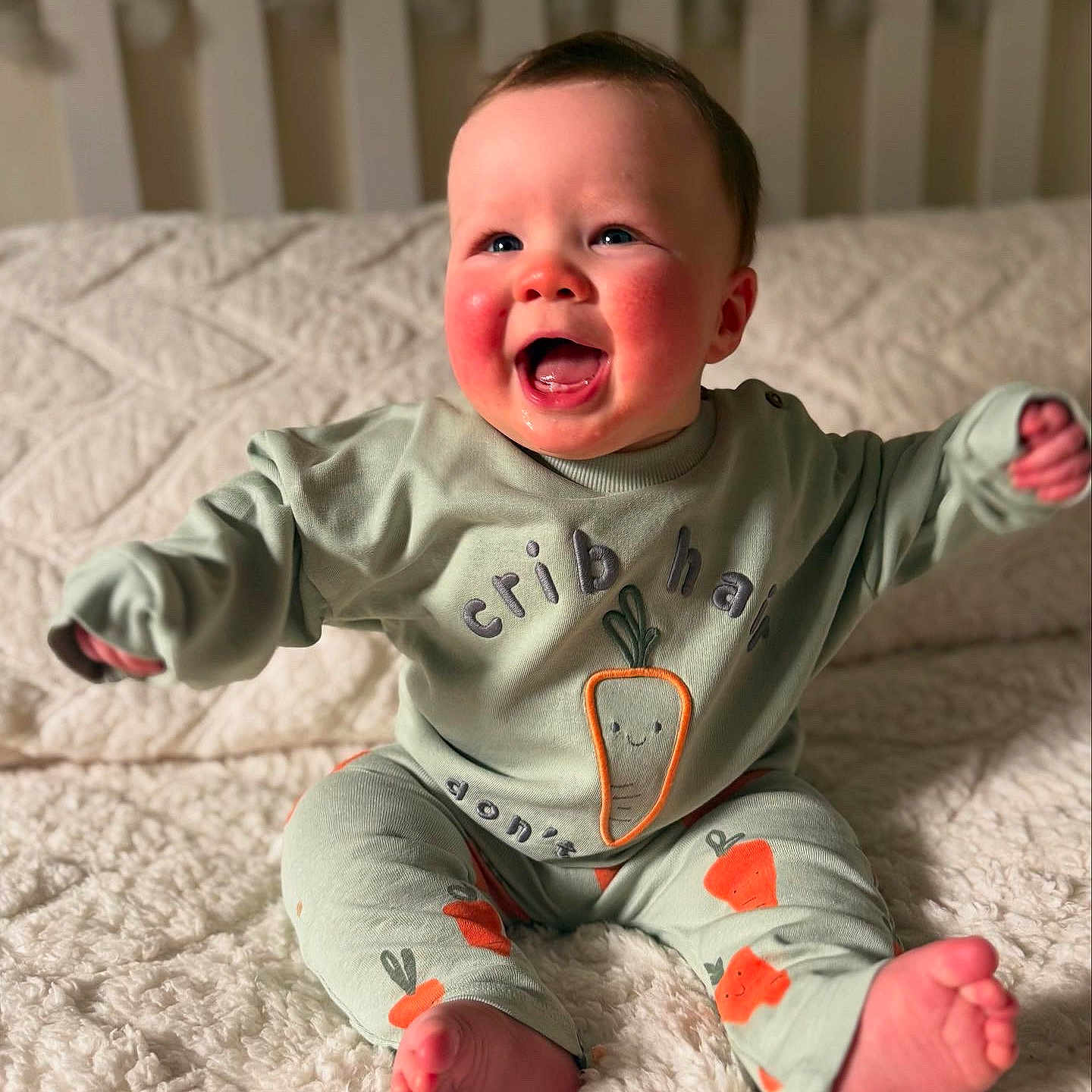 Reuben is registered to the contest to win money with this photo: baby, babylaughing, clothing, face, happy, head, pajamas, person, photography, portrait, sitting