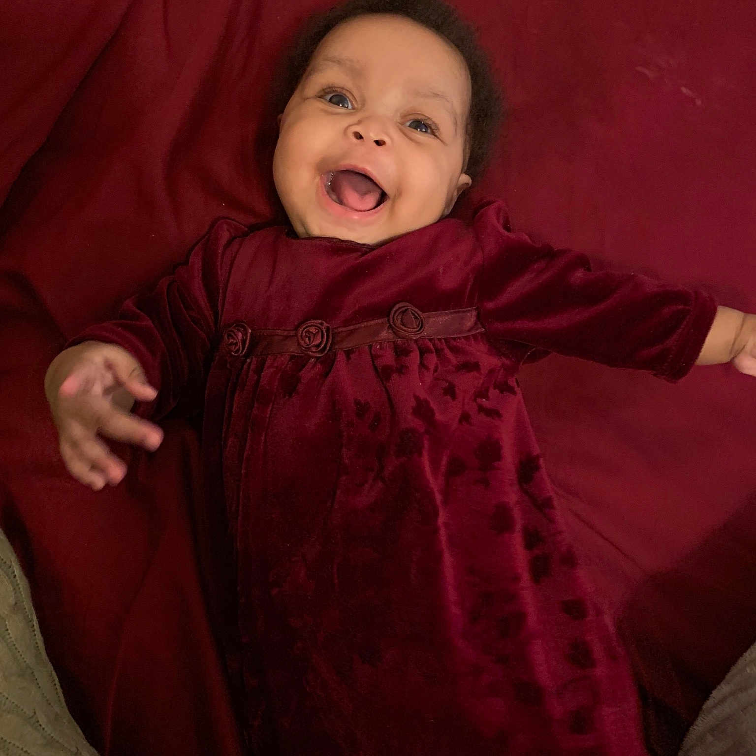 Collette is registered to the contest to win money with this photo: baby, cheek, child, eye, face, facial_expression, fun, happy, head, laugh, nose, person, portrait, portrait_photography, red, sitting, skin, smile, toddler