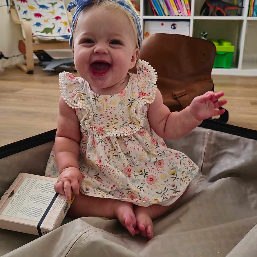 Abigail is registered to the contest to win money with this photo: architecture, baby, bodypart, building, chair, couch, face, finger, furniture, hand, happy, head, indoors, livingroom, person, photography, portrait, room, shelf, wood