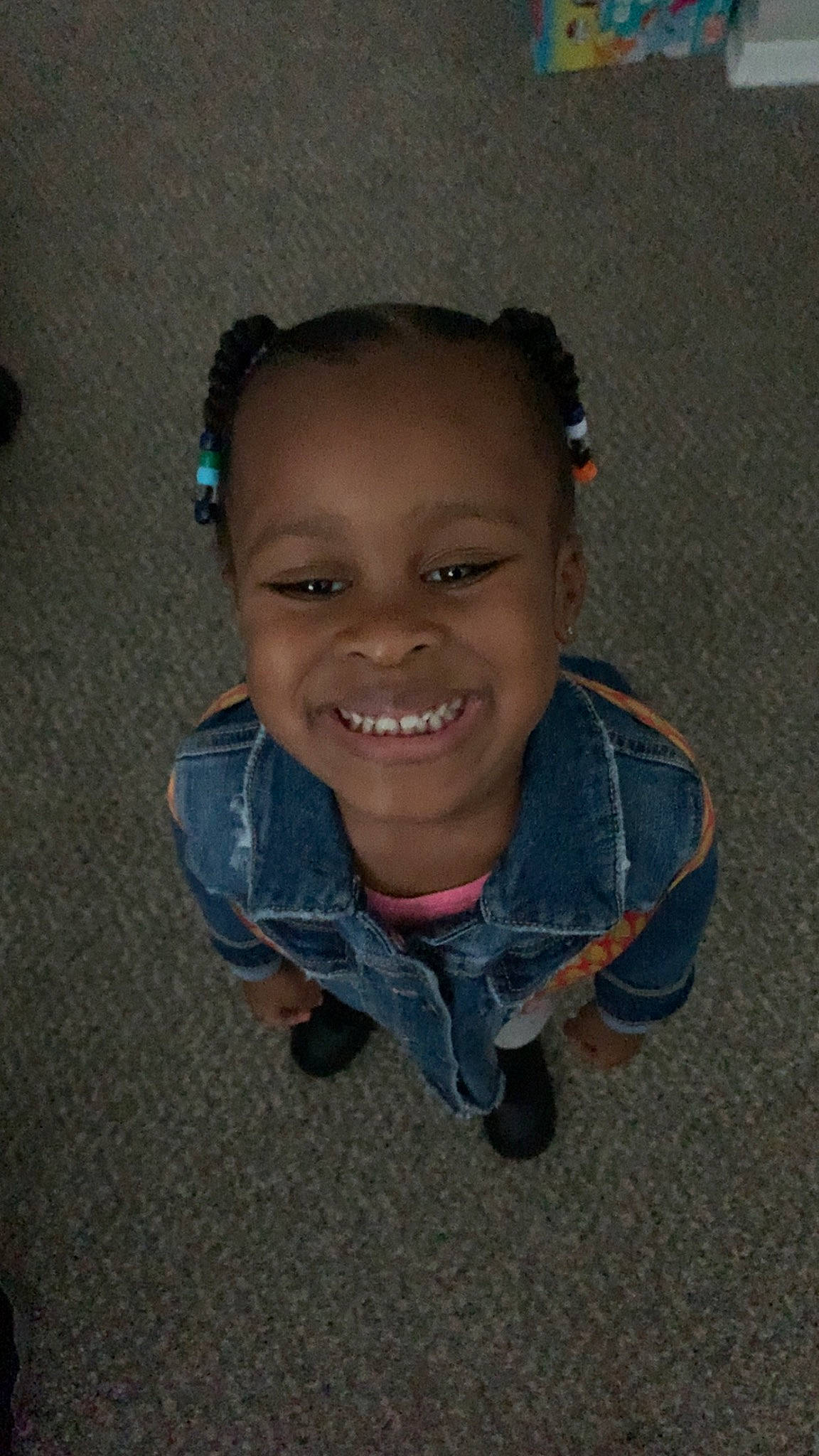 Amara is registered to the contest to win money with this photo: audio_equipment, baby_toddler_clothing, cheek, child, denim, electric_blue, flooring, fun, happy, iris, joy, laugh, nose, person, road_surface, sitting, sleeve, smile, toddler