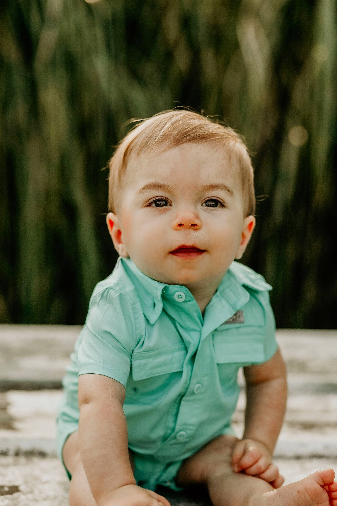 Kohen is registered to the contest to win money with this photo: baby, baby_toddler_clothing, cheek, child, clothing, eye, face, flash_photography, fun, grass, happy, head, leisure, people_in_nature, person, sitting, skin, sleeve, smile, toddler