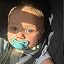 baby, pacifier, face, infant, child, sunlight, shadow, close_up, car_seat, seatbelt, clothing, cute, skin, eyes, expression, portrait, indoors, young, head, human