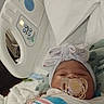 Leilani is registered to the contest to win money with this photo: baby, bassinet, blanket, bow, child, cozy, face, headband, hospital, hospital_bed, indoors, infant, medical_equipment, newborn, pacifier, photography, portrait, sleeping, swaddled, textile