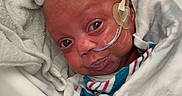 Demetria is registered to the contest to win money with this photo: baby, infant, hospital, medical, nasal_tube, blanket, towel, white, bed, healthcare, newborn, patient, face, portrait, wrapped, small, cute, lying, indoors, care