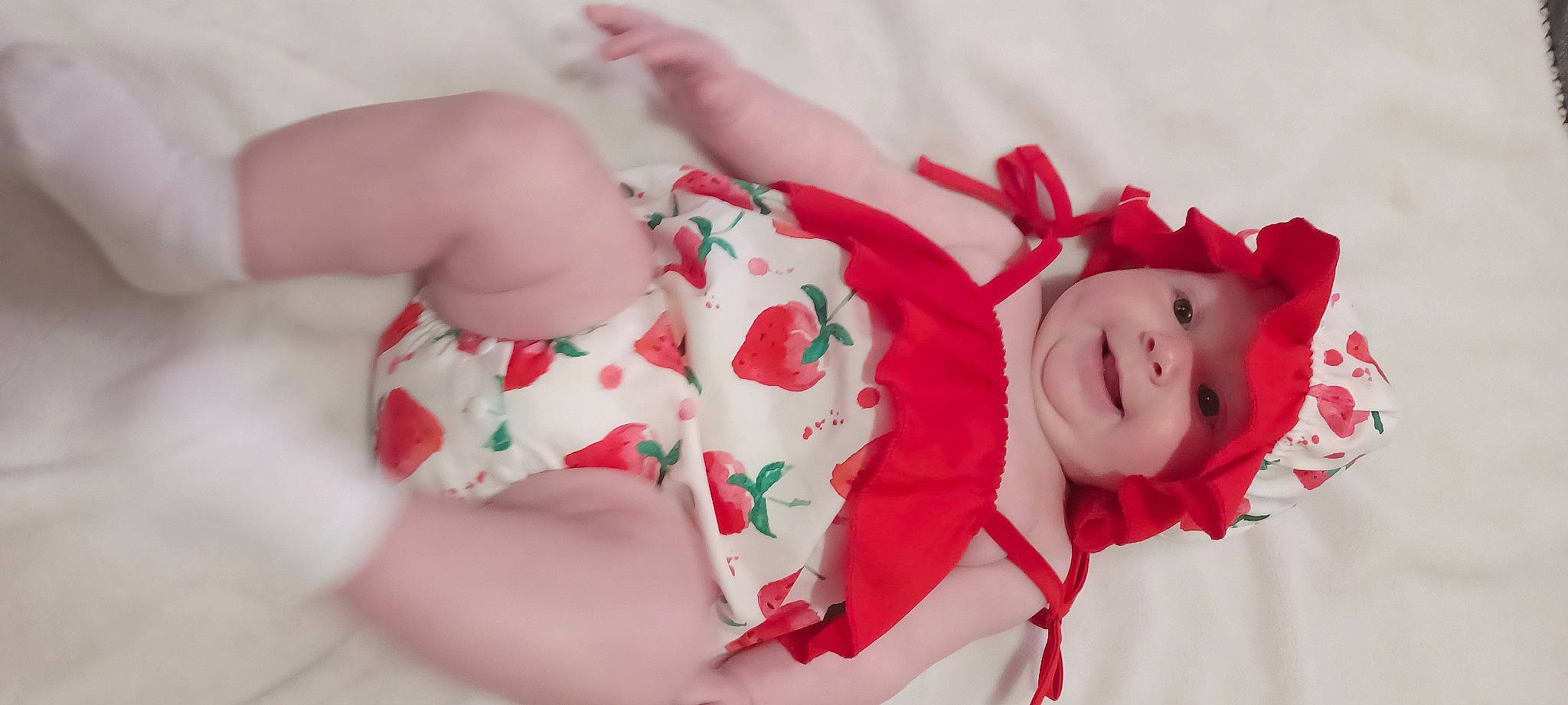 Harper is registered to the contest to win money with this photo: baby, baby_toddler_clothing, carmine, chest, child, christmas, event, happy, hat, headwear, human_body, human_leg, joy, pattern, person, petal, pink, smile, sweetness, textile