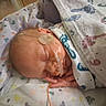 Ryder joined the competition — help win amazing prizes! newborn, baby, sleeping, infant, hospital, blanket, swaddled, medical_tube, medical_monitoring, umbilical_cord, nursery, portrait, close_up, head, hand, ear, face, patterned_fabric, resting, healthcare