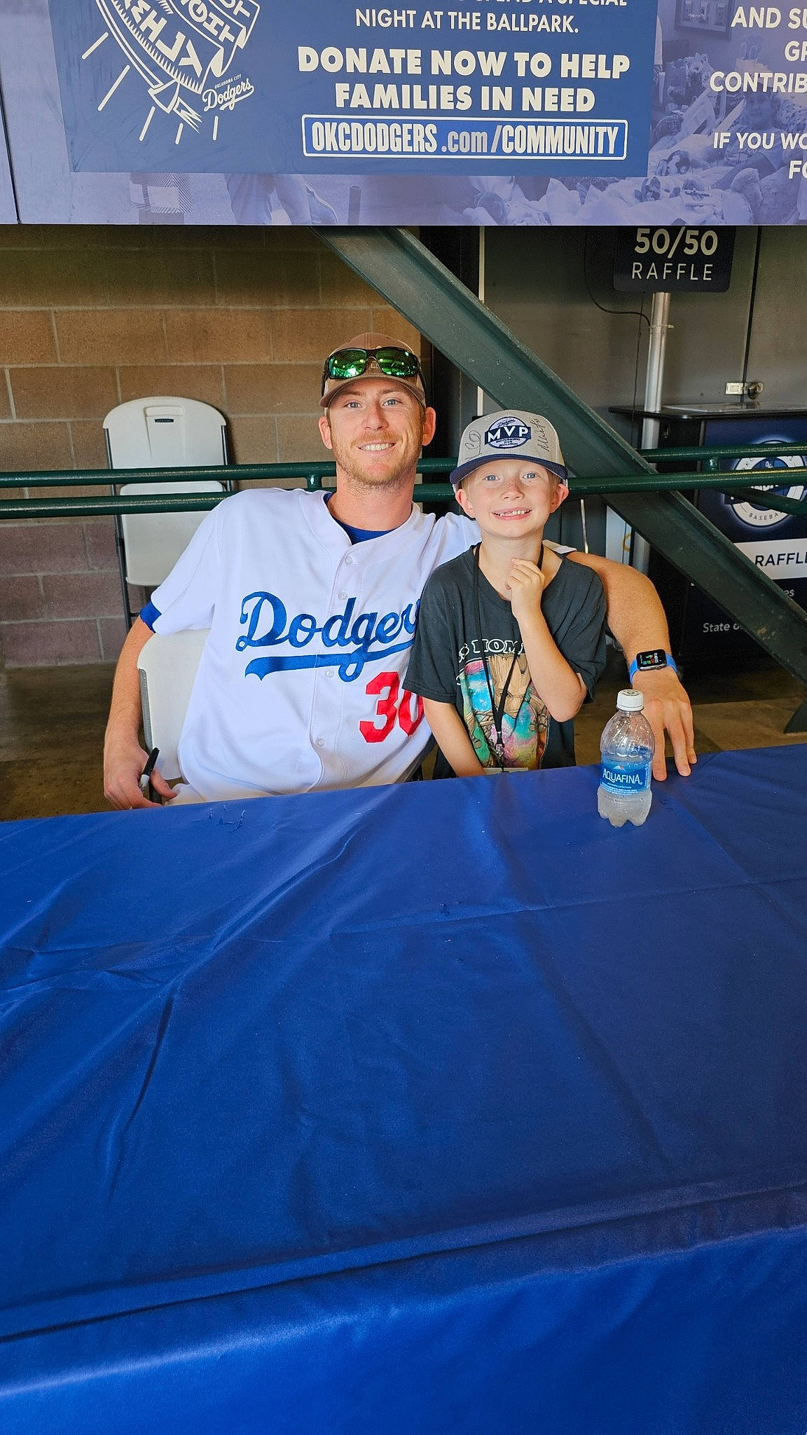 Garrett is registered to the contest to win money with this photo: baseball, baseball_cap, bottle, cap, competition_event, electric_blue, event, fan, fun, hat, headwear, jersey, joy, person, player, recreation, sleeve, smile, sports_uniform, sportswear