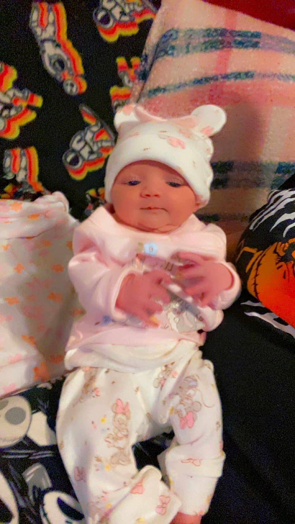 Emma joined the competition — help win amazing prizes! baby, infant, pajamas, hat, blanket, cartoon_characters, pink_clothing, white_clothing, cute, indoors, soft_toys, sleepwear, newborn, person, child, portrait, lying_down, hands, face, cozy