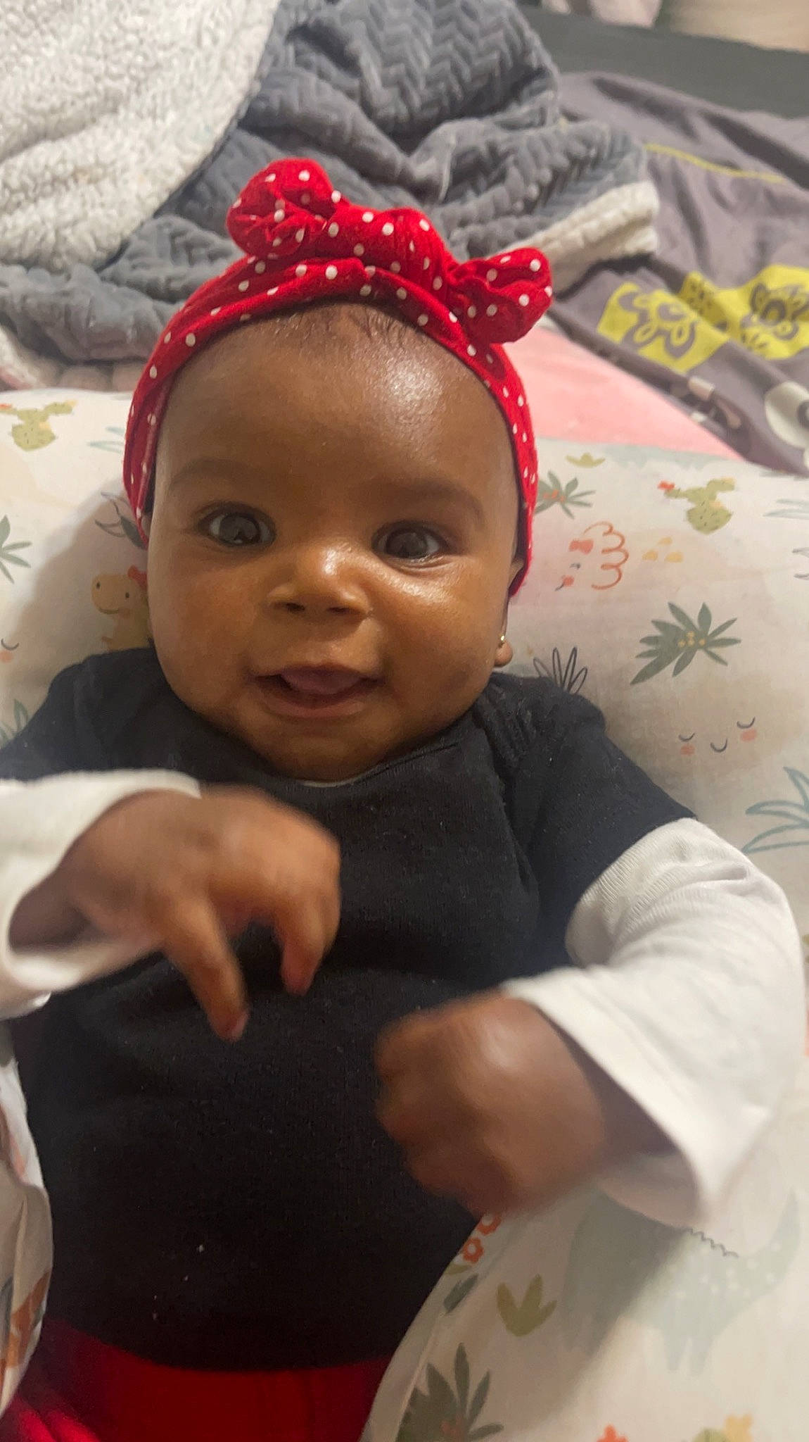 Karlie is registered to the contest to win money with this photo: baby, cheek, child, costume_hat, dress, eye, fashion_accessory, happy, headgear, human_body, jewellery, linens, lip, nose, person, room, skin, smile, toddler, tradition